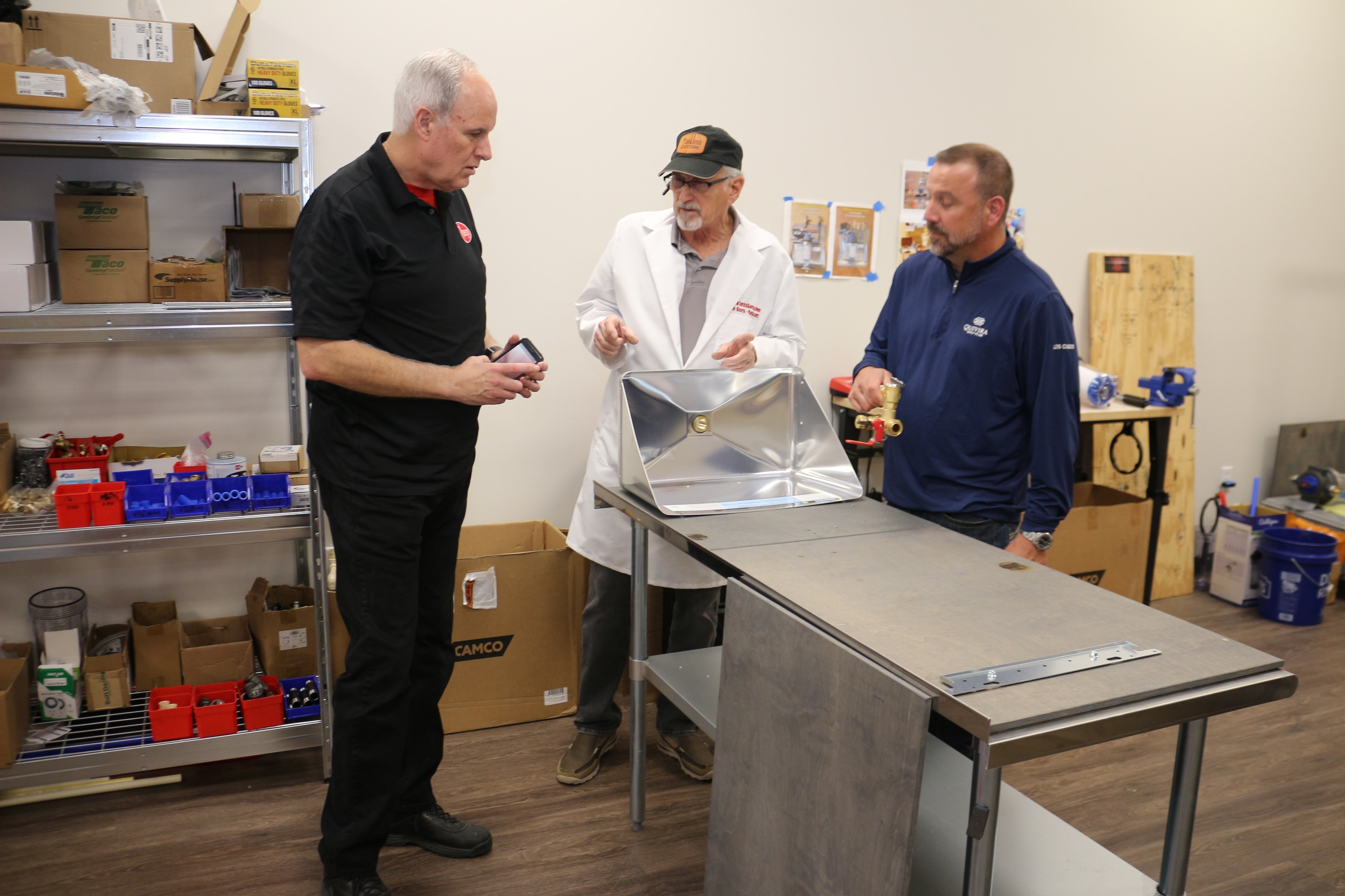 Ray Scott, founder of TanklessGuru.com, demonstrating a Pre-Assembly to Rheem Corp. executives